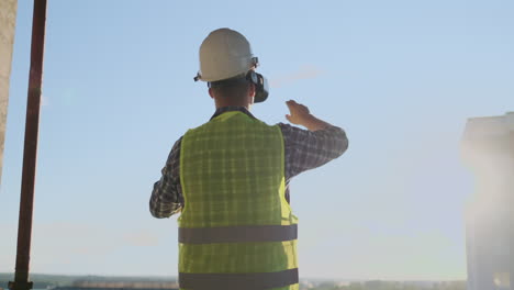 Builder-working-with-VR-glasses.-Builder-projecting-with-VR-glasses-future-exterior-standing-at-the-construction-site