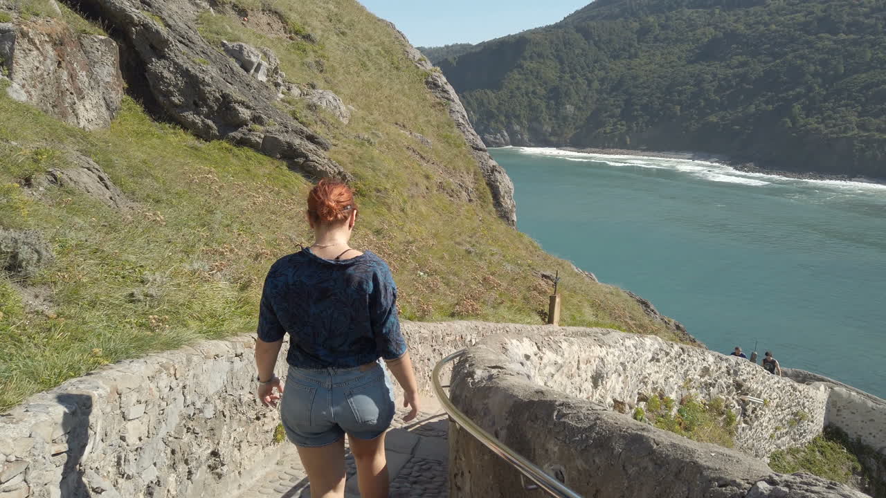 Coastal landscape with person on stone stairs