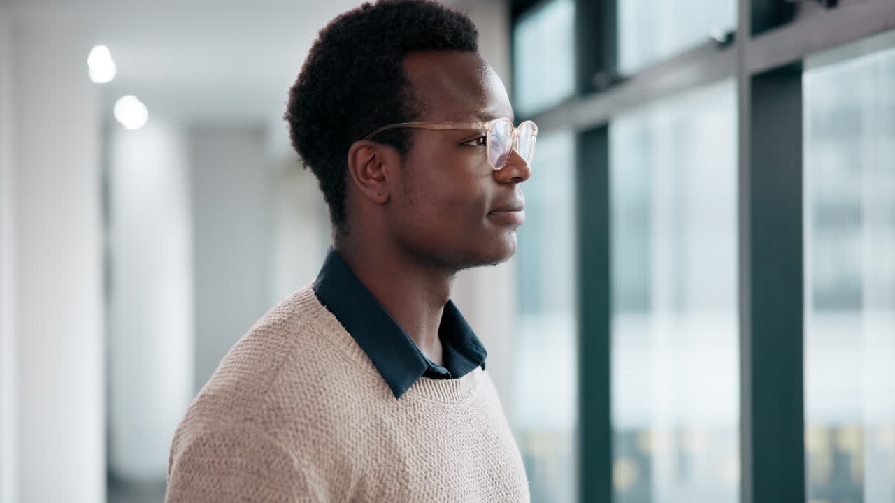 Man looking out of office window