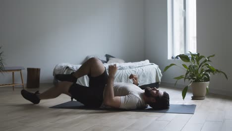 man stretching at home