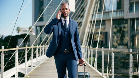 businessman walking on a bridge with suitcase