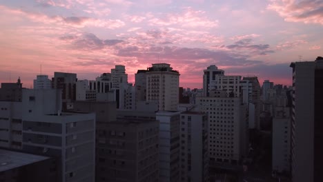 Unbelievable-aerial-4k-shot-of-Sao-Paolo-city-center-in-evening,-beautiful-sunset-with-crazy-color-sky-and-sun