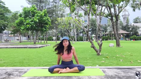 woman practicing yoga in a park