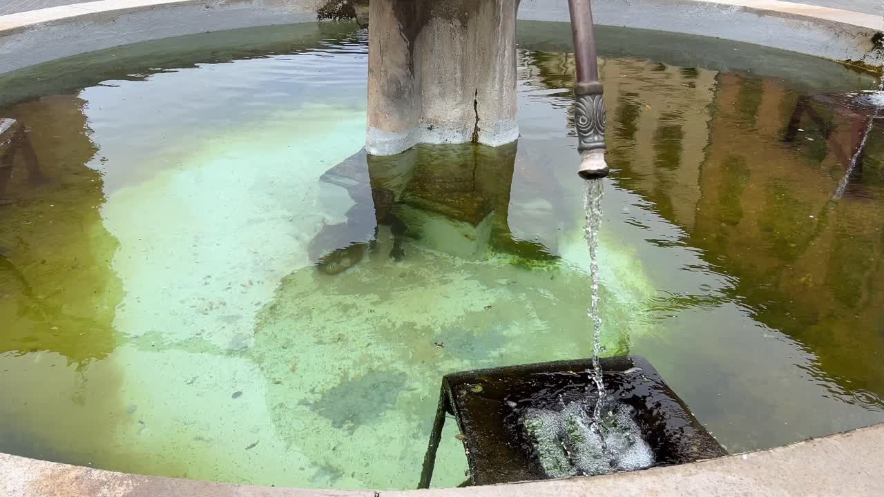 Wishing well, with running water with green water
