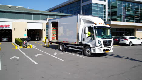 grocery delivery truck loading at supermarket
