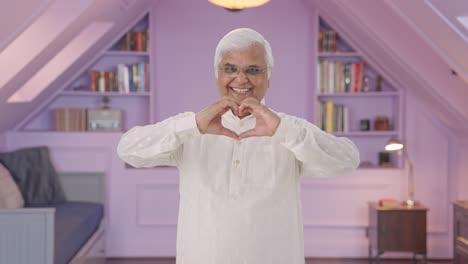 Happy-Indian-old-man-showing-heart-sign