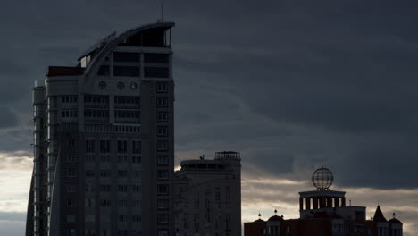 drone shot high-rise building in residential area. ominous changing weather.