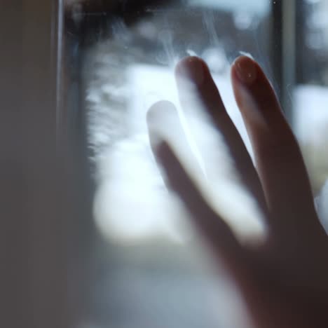 human hand on window