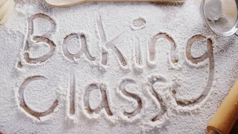 the word baking class written on sprinkled flour 4k