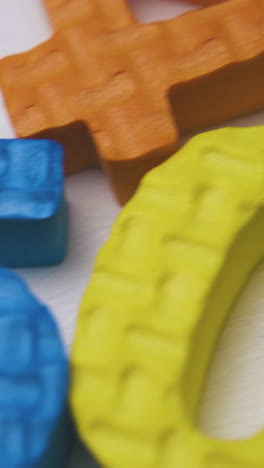 motion over colorful foam rubber numbers lying on clean white background extreme close view