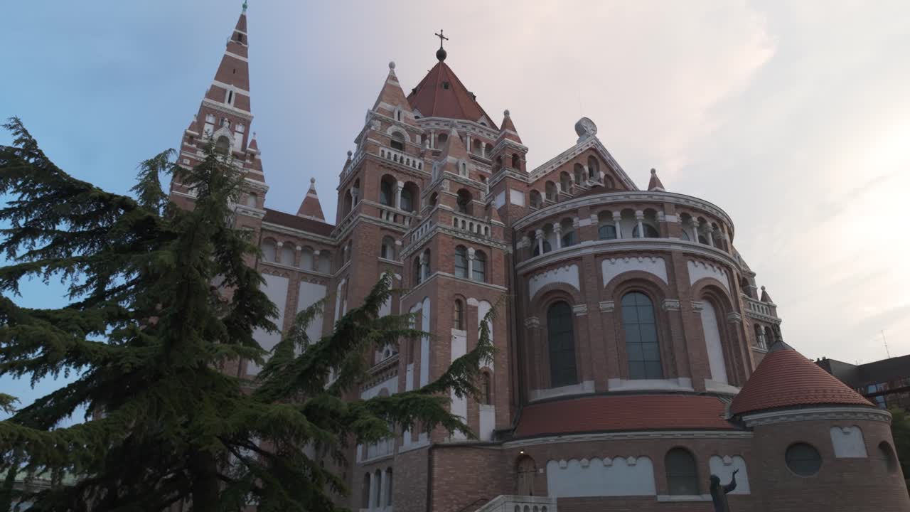 Ground-level view of Szeged’s Votive Church, highlighting its towers and historic architecture