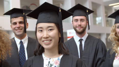 happy group of student graduates in traditional cap and gown