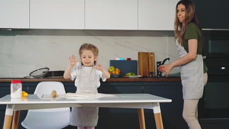 daughter and mother prepare food in kitchen