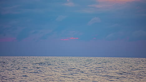 timelapse of the majestic cloudscape over the sea at twilight, with the waves moving