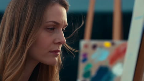 a woman painting outdoors