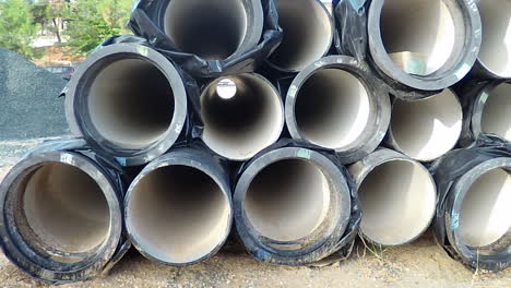 piles of tubes on the roadside, for underground drainage