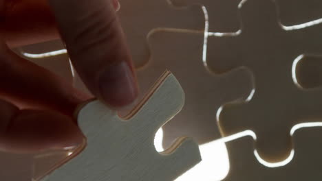 animation of hand of caucasian woman playing wooden puzzle