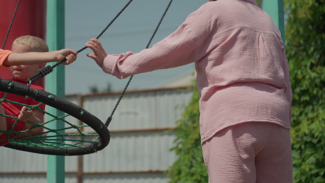 Grandmother And Grandchildren Play Happily Outside, Elder Observes Joyful Children During Outdoor Activities, Relaxed Family Members Engage In Cheerful Outdoor Recreational Activities Together