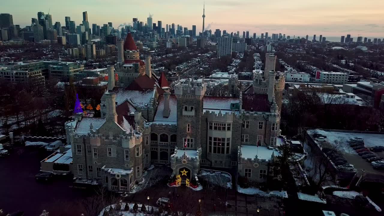 Beautiful Aerial Scene of Casa Loma and Toronto City Skyline at Sunset. Charming Scenic Landmark in a Modern City at Sunset in the December Christmas Holiday Season, Aerial Establishing Shot Reveal