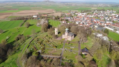 Aerial-of-a-Chapell-and-a-medieval-Tower-on-a-Hill,-Wettenberg,-Hesse,-Germany
