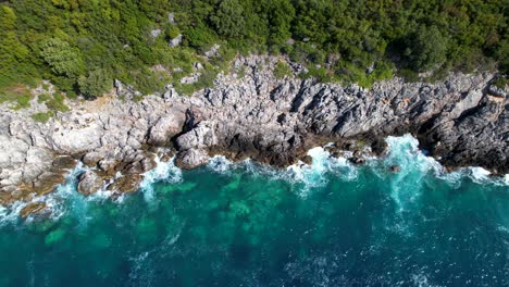 epic rocky coastline with great cliffs splashed by waves, beautiful seascape with green turquoise colors