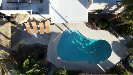 backyard swimming pool in luxury real estate house - top down aerial view