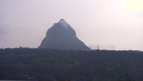 one alone house top on the mountain and behind big motain point pawana lake