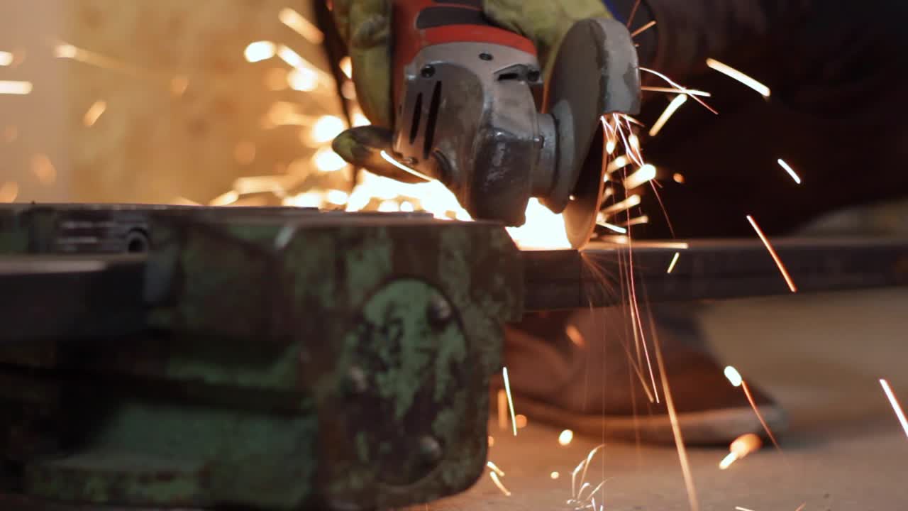 Saw grinder slicing a iron rod with fire sparks erupting