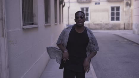 stylish man running down an alley