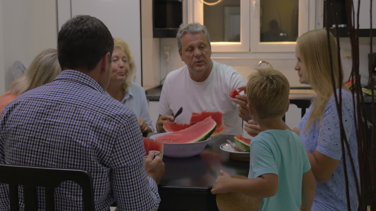 Family enjoying sweet ripe watermelon
