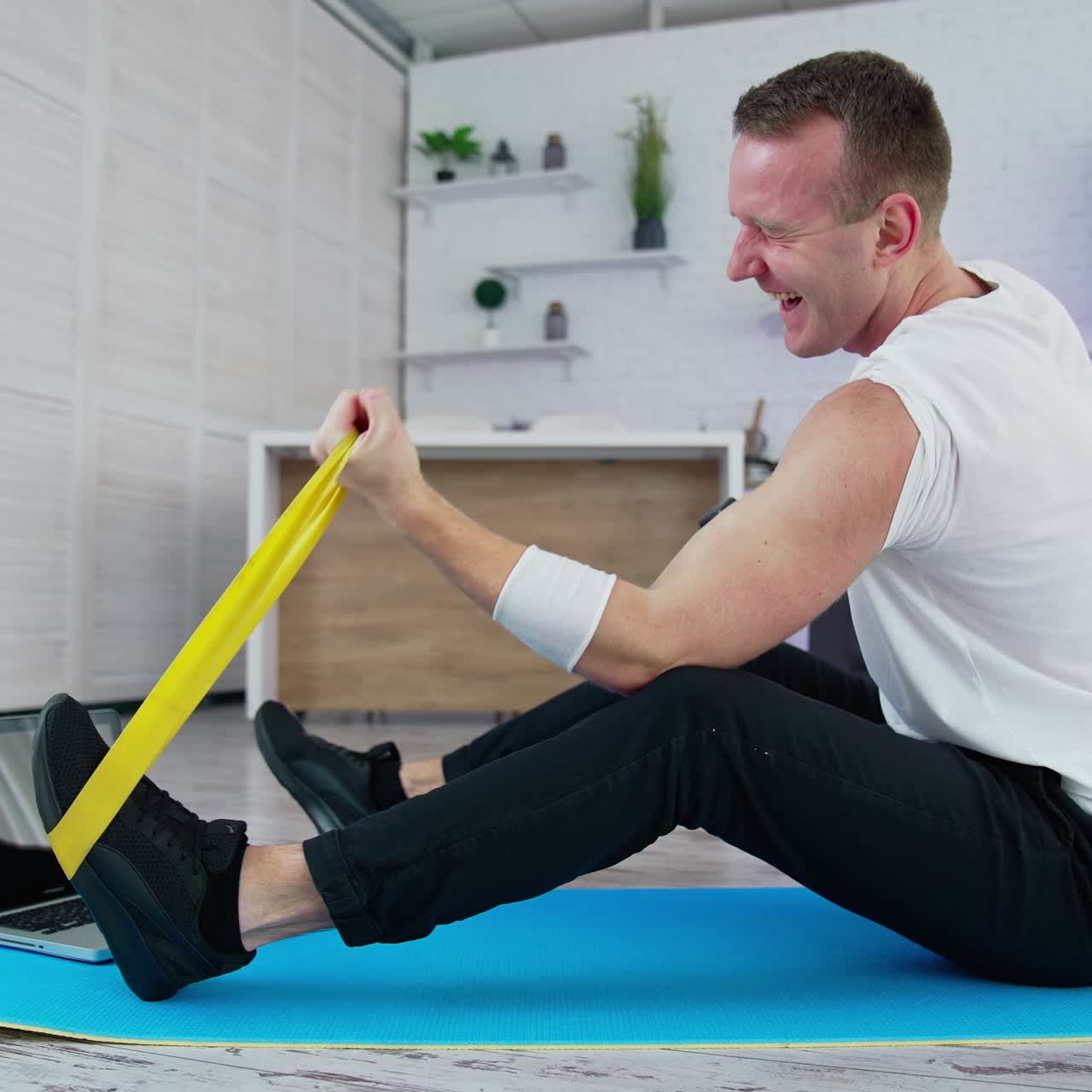 Athletic handsome man working out in home. Strong healthy man training indoor on quarantine