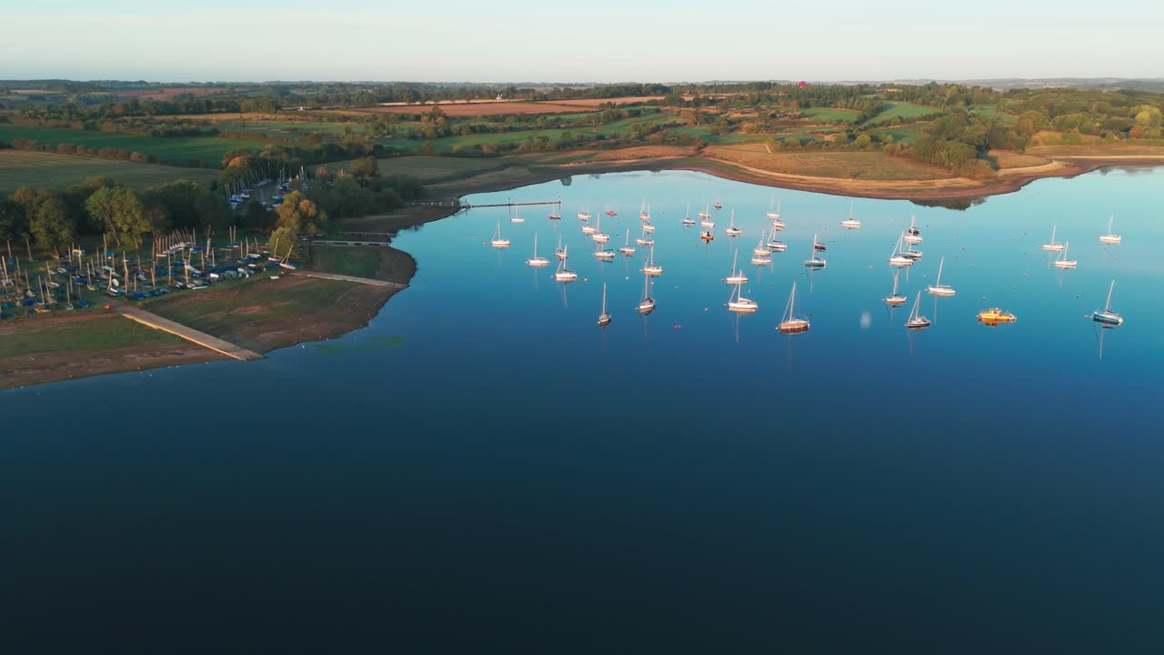 Boats sailing Oakham Rutland water reservoir, aerial drone nature reserve