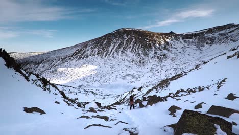 A-person-hiking-in-a-snowy-mountains