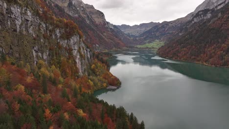 serene autumn view of klöntalersee lake and surrounding mountains in glarus, switzerland