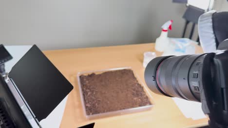 camera setup captures soil in a studio environment with controlled lighting and macro focus