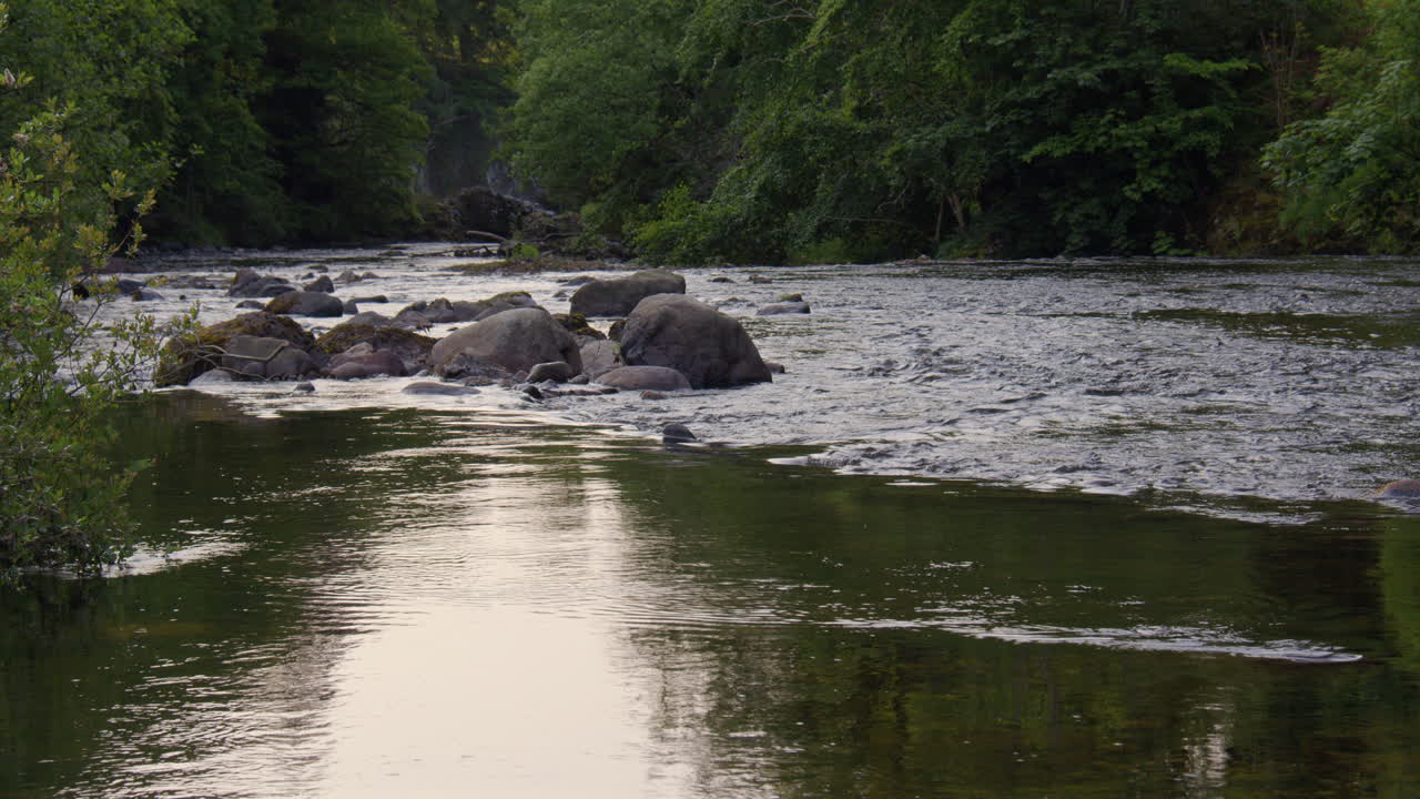 Mid shot looking down stream of the river Isla at the Bridge Of Craigisla