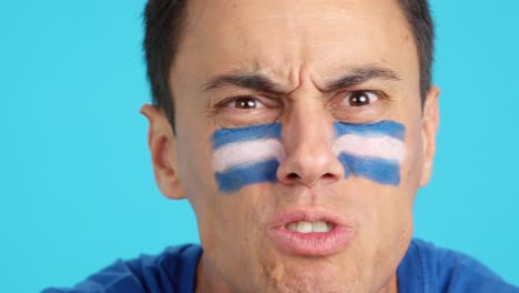 man with salvadoran national flag upset with a referee