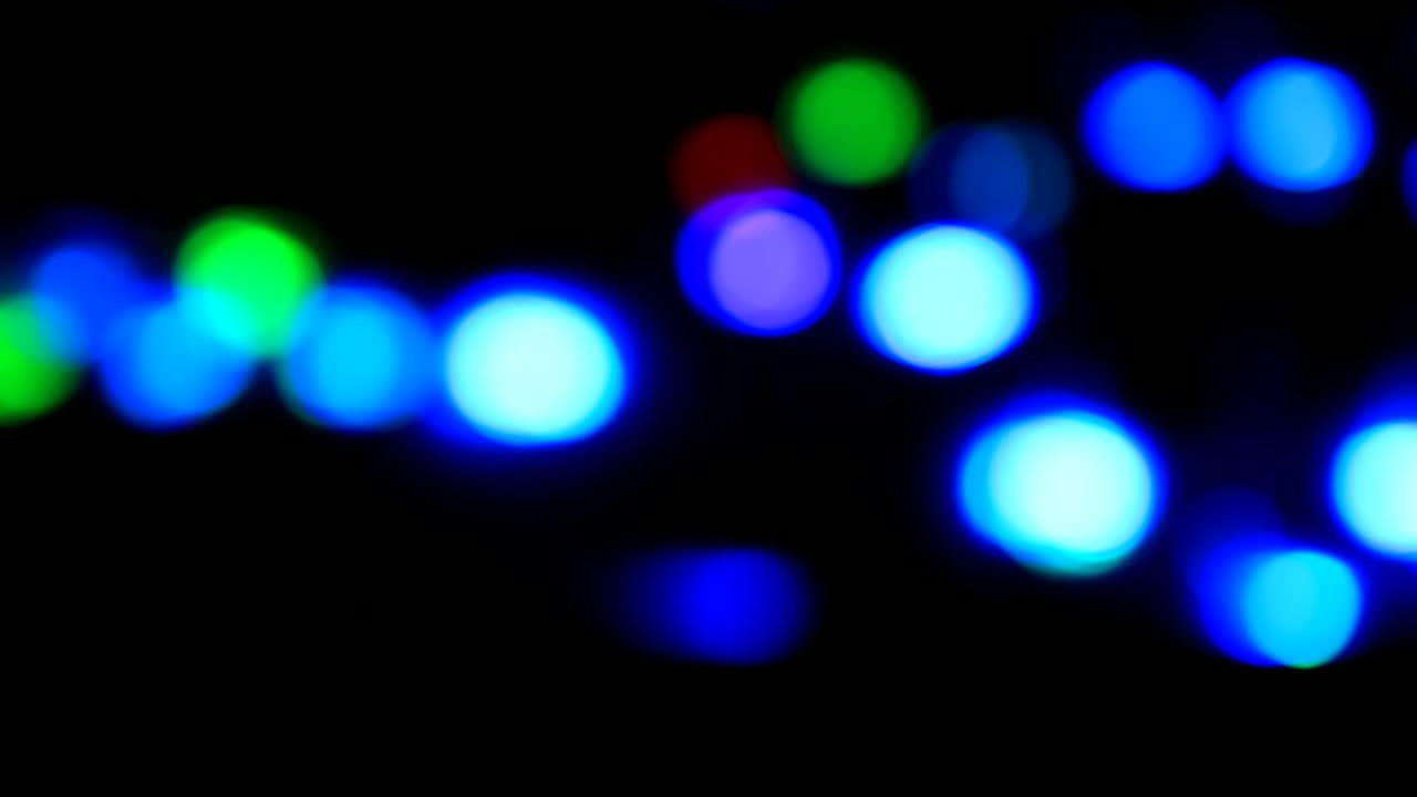 Bokeh video, the effect of lights in the water, with a black background