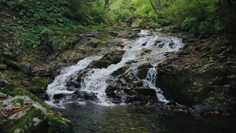 Water-flowing-down-peaceful-mountain-stream-near-Amidaga-Taki-Falls