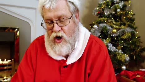 Santa-claus-sitting-near-fireplace