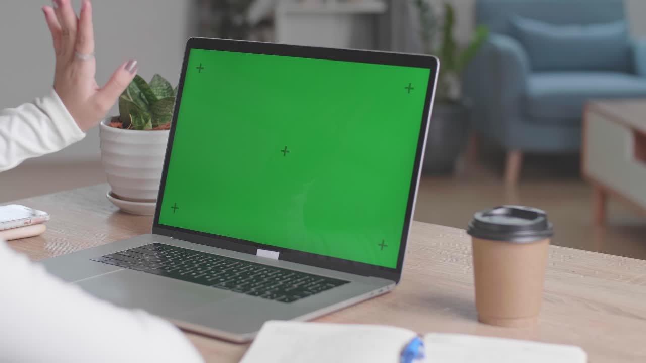 Close Up Hands Waving During Video Call On Laptop Computer With Green Screen Display At Home, Video In 4K