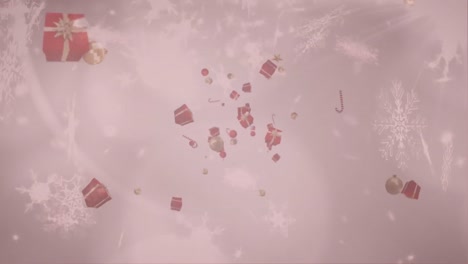 christmas presents, candy canes and baubles against snowflakes falling on grey background