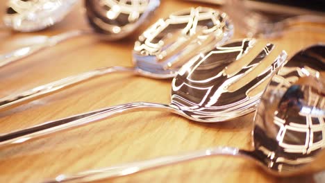 a close-up of a set of shiny silver serving spoons