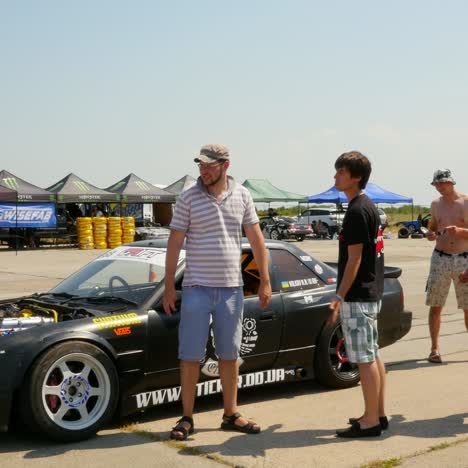 people in drift show visiting powerful cars