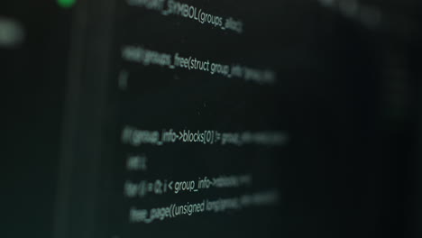 extreme close up shot of hacking code running on computer system monitors