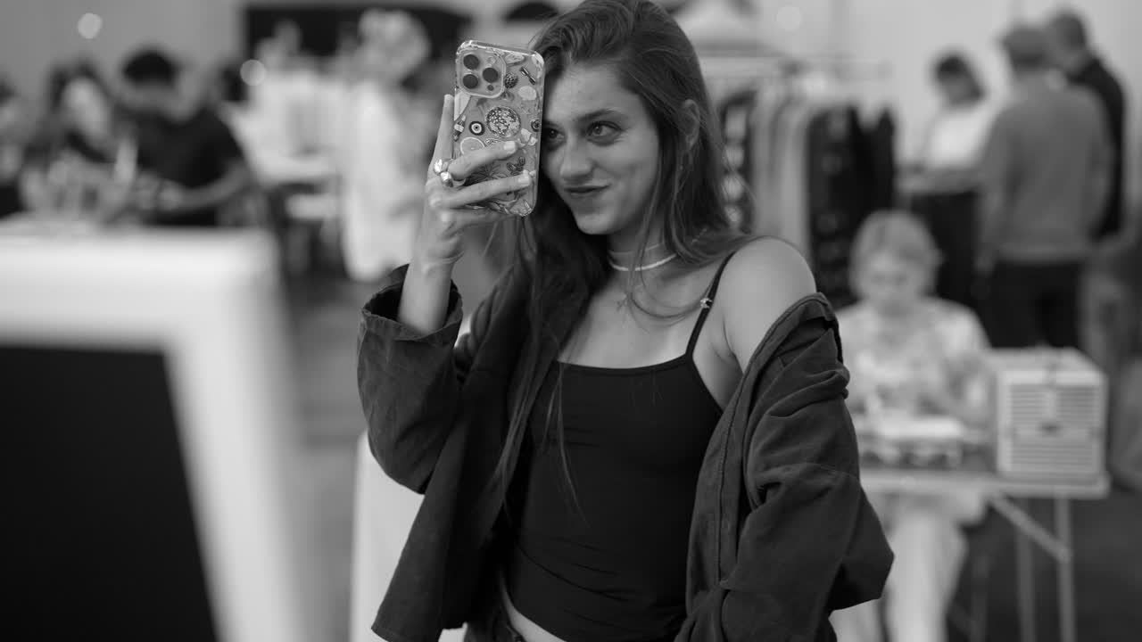 A woman takes a selfie at an event