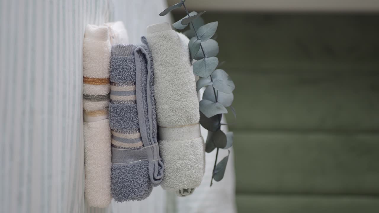 Arrangement of towels and eucalyptus