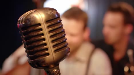 close-up shots of a vintage microphone capturing the essence of live music performance with a focus on sound and atmosphere in a cozy setting