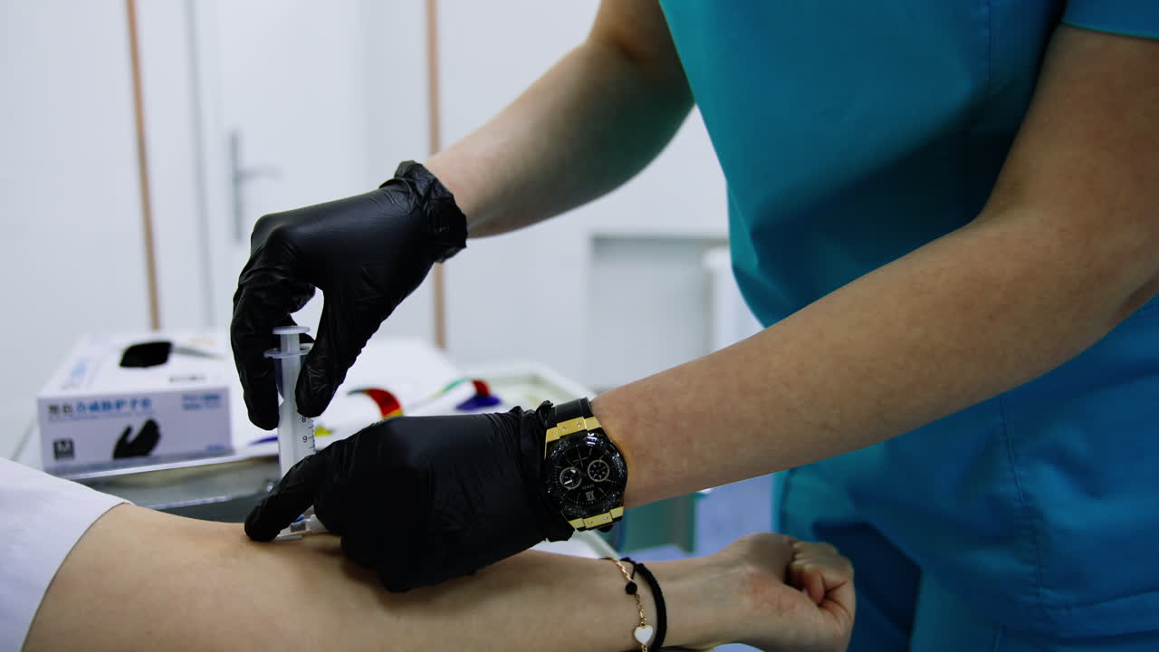 Doctor inserting medicines from a syringe into a catheter. Medic extracts the squirt and clothes catheter cap.