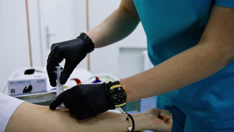 doctor inserting medicines from a syringe into a catheter. medic extracts the squirt and clothes catheter cap.